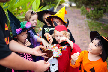 Kids trick or treat. Halloween. Child at door.