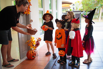 Kids trick or treat. Halloween. Child at door.