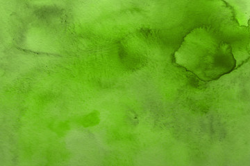 Colorful green watercolor texture with abstract washes and brush strokes on the white paper background. Chaotic abstract organic design.