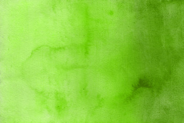 Colorful green watercolor texture with abstract washes and brush strokes on the white paper background. Chaotic abstract organic design.