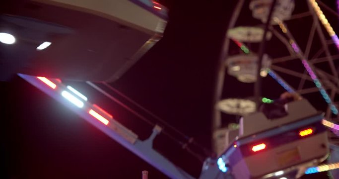 Amusement park rides lit up at night