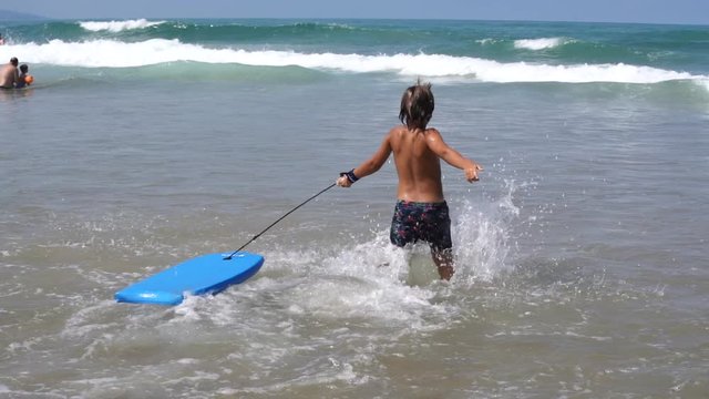 Young children bodyboarding in the Atlantic ocean