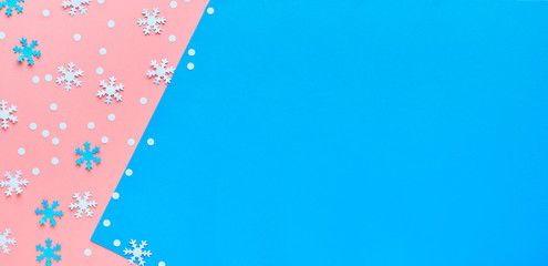 Merry Christmas! Creative paper flat lay in pink, blue and white with snowflakes