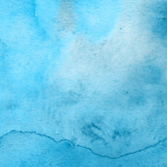 Blue watercolor winter texture with abstract washes and brush strokes on the white paper background.