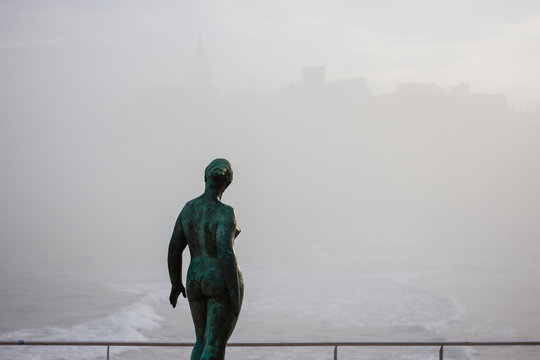 Naked woman statue in foggy Sitges, Spain