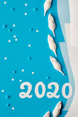 Paper flat lay in blue and white with marshmallow mice and paper number 2020