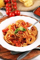 Plate of delicious spaghetti Bolognaise or Bolognese with savory minced beef and tomato sauce garnished with parmesan
