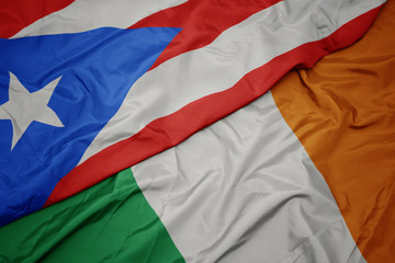 waving colorful flag of ireland and national flag of puerto rico.