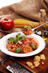 Plate of delicious spaghetti Bolognaise or Bolognese with savory minced beef and tomato sauce garnished with parmesan