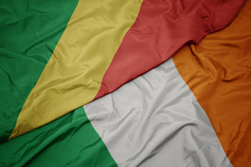 waving colorful flag of ireland and national flag of republic of the congo.