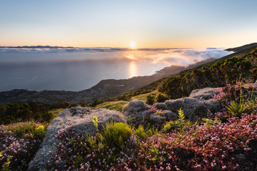 Sunrise landscape at the northeast coast of Pico Island, Ilha do Pico, with Sao Jorge Island in the...