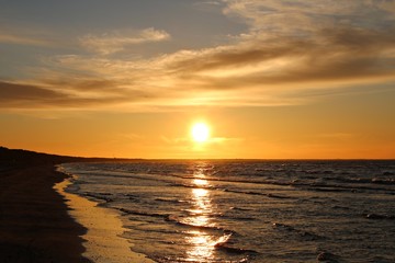 Bright orange sunset on the coast of the Gulf of Riga at the end of summer