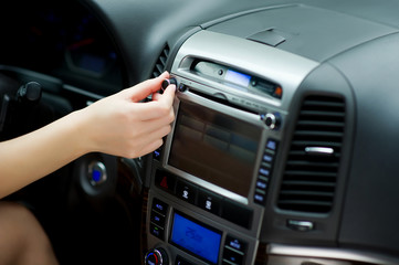 hand tunes in radio stations and adjusting sound volume on the car audio system. Parameter settings through the on-board computer. close-up
