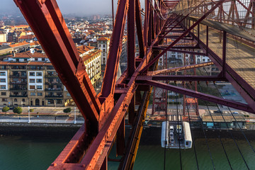 The gondola of Vizcaya Bridge carrying cars and passengers viewed form top, Portugalete, Basque...