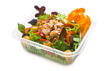 Healthy tuna salad in a takeaway plastic container. Tuna, red pepper in strips, steamed potatoes, assorted lettuce and sweet potato chips.