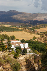 View of the old bridge in Ronda with the Serrania in the background