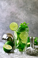 Citrus cocktail mojito with lime and mint in a tall glass.