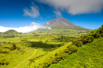 Aerial image of typical green volcanic caldera crater landscape with volcano cones of Planalto da...