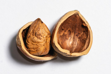 Cracked hazelnut on bright background, top view