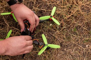 man hands work on the DIY drone on the ground