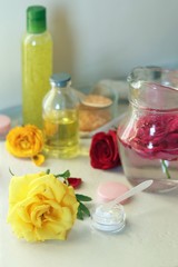 Fototapeta na wymiar Roses, soap, petals, body care products, oil on the table, spa treatments, preparation of natural cosmetics, healthy lifestyle