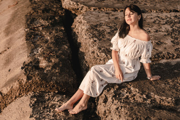 beautiful young brunete woman enjoys the beautiful view on the beach and has a good sunrise time. Relax