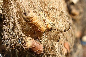Old fishing net background with birch bark flouts and clay leads