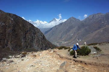 Fototapeta na wymiar Trekker on the trail to Ama Dablam base camp - acclimatization day walk from Pangboche village, Everest trek, Sagarmatha national park, Solukhumbu, Nepal