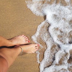  female feet in golden sand