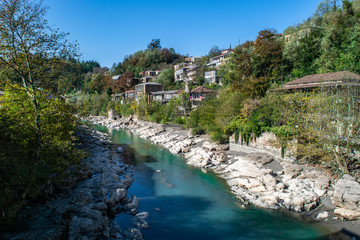 Homes along the rocky banks of the Rioni River in Kutaisi, Georgia