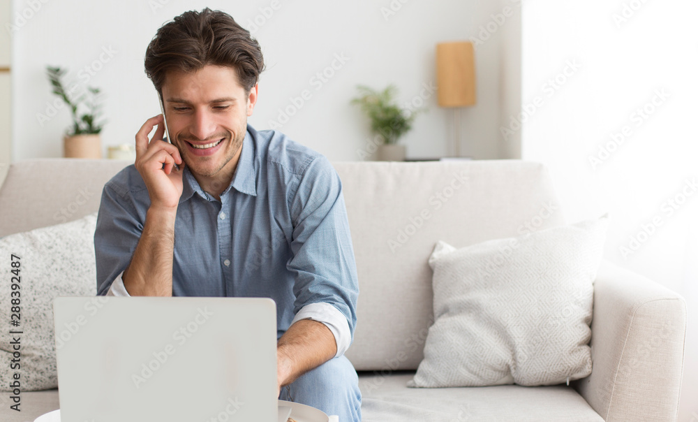 Poster man using laptop talking on cellphone with customer support operator