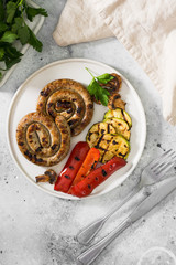 Sausages grilled on the gray plate. Gray background