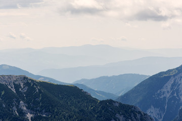 Obraz premium view of mountain peaks in haze, Alps
