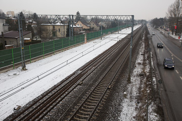 Train tracks and a road, in a snowy day, Warsaw, Poland