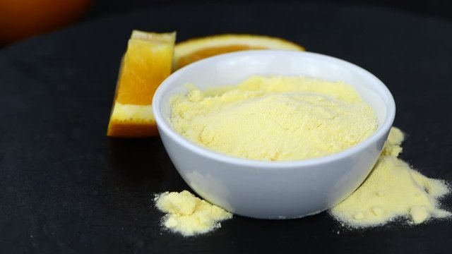 Portion of Orange powder (rotating, seamless loopable; 4K)