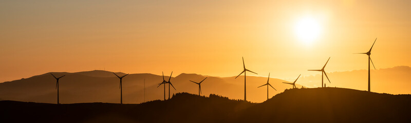 A windfarm with wind turbines at Planalto dos Graminhais in a poetic sunset setting, serving as a perfect image for green sustainable renewable engery. - obrazy, fototapety, plakaty