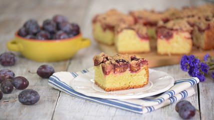Rustic style. Homemade plum cake on wooden table.