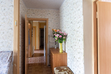 Corridor of a three-room apartment with an outdated interior