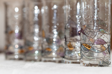 Abstract background of a row of tall glasses of thin glass decor
