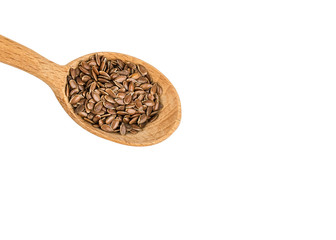 Flaxseeds in a wood spoon on a white background. Linseed is scattered.