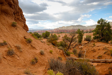 Hiking in Rugged Terrain of Utah High Desert Country with Dark Cloud over Distant Mountains