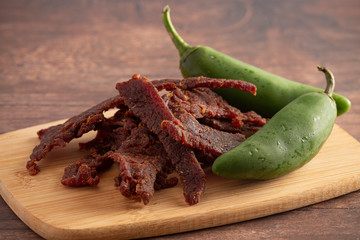 Jalapeno Flavored Gourmet Beef Jerky on a Wooden Cutting Board