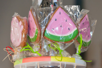 Colorful hard candy lollipop in shape of watermelon. Candy shop concept.