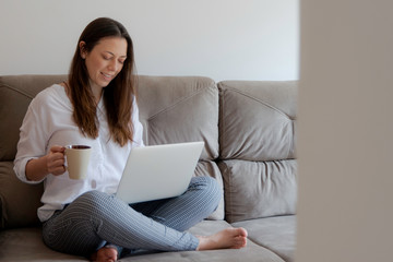 Business lady drinking tea and working at her home. Space for text.