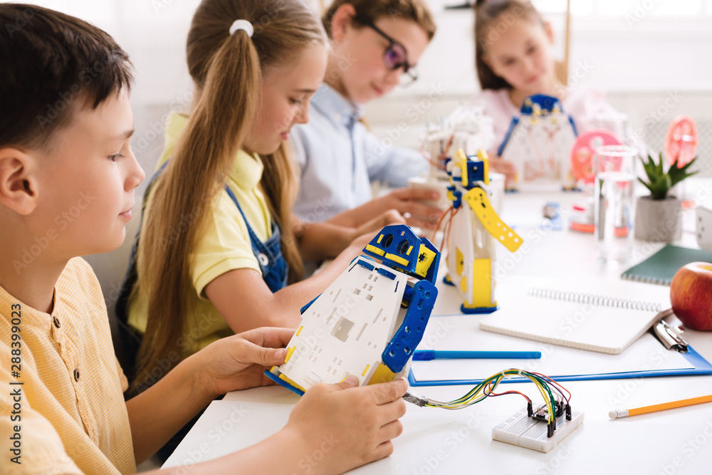 Poster smart boy making diy robot at stem lab