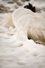 Close-up of Foamy Water Splashing onto Shore
