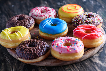 Glazed donuts on wooden background top view