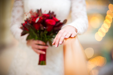 the bride holds her hand with a ring on it on a wooden railing