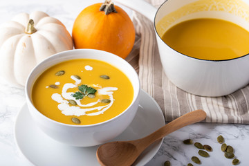 traditional squash soup with pumpkin on background