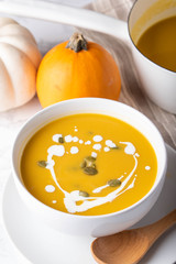 traditional squash soup with pumpkin on background